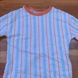 Art Class t-shirt with orange and blue stripes.